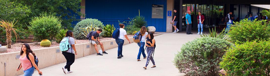 Students walk between the breezeways at Pima's West Campus